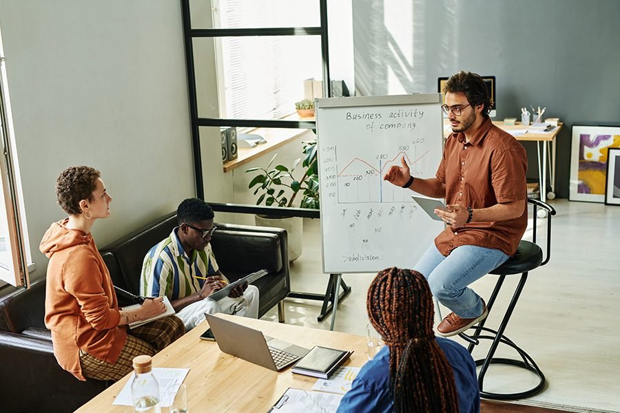 young-confident-business-coach-sitting-by-whiteboa-Z8VCDCY.jpg young-confident-business-coach-sitting-by-whiteboa-Z8VCDCY.jpg